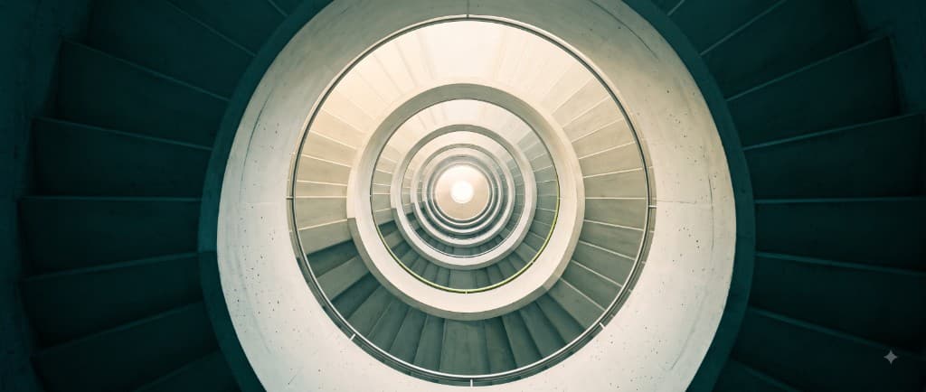 Looking down a spiral staircase toward light